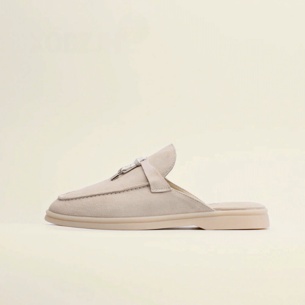 Women’s premium suede loafers with backless design and tassel accent in beige color.