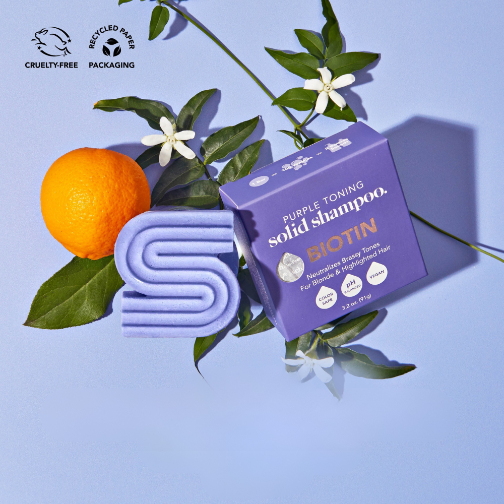 Biotin purple toning solid shampoo bar set with orange and green leaves, eco-friendly and cruelty-free packaging.