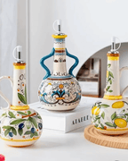 Hand-painted ceramic olive oil dispensers with colorful designs and leak-proof spouts, perfect for kitchen decoration.