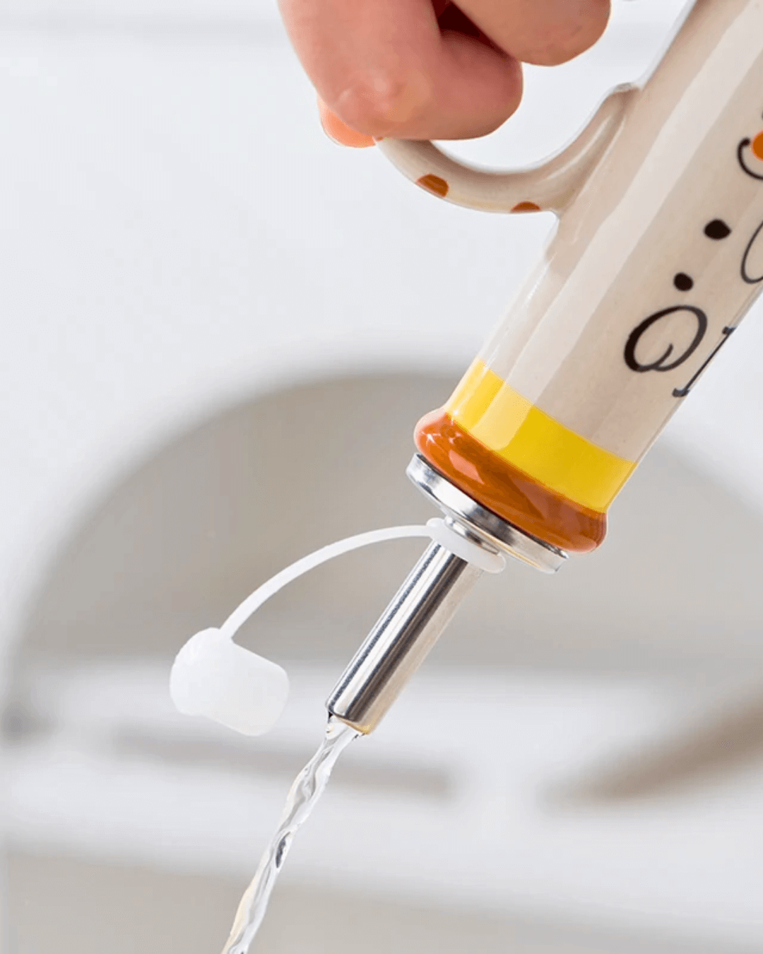Hand-painted ceramic olive oil dispenser with a sleek metal spout pouring oil, showcasing its functional design.