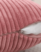 Close-up of a soft pink corduroy decorative pillow cover with zipper, showcasing its boho style and texture.