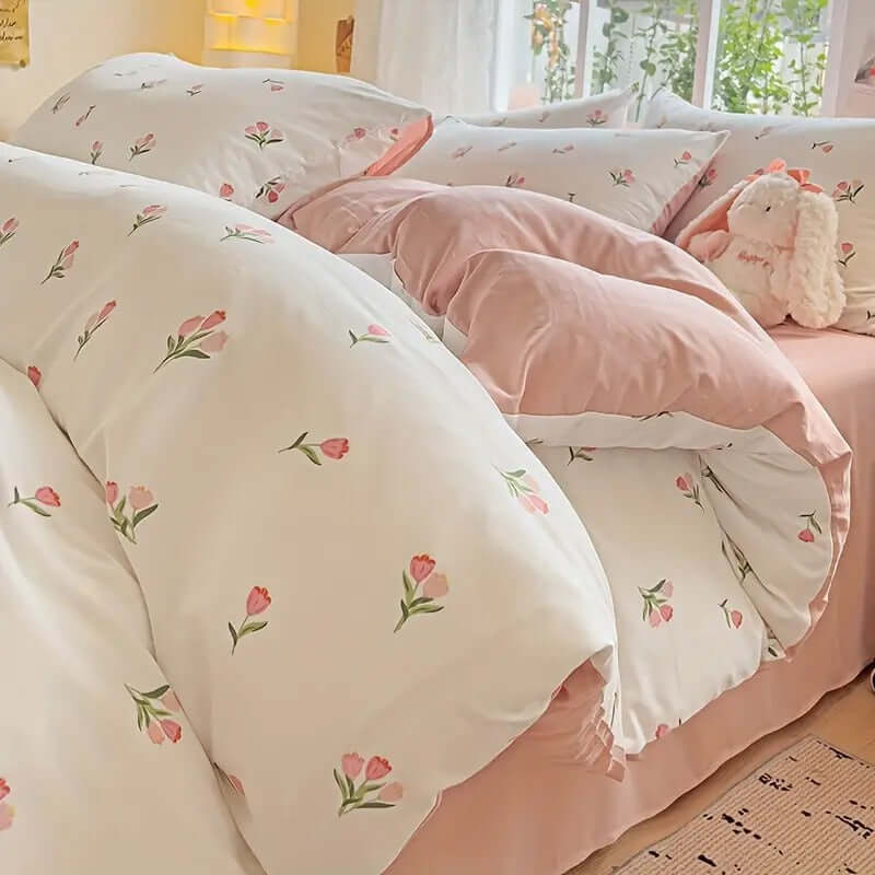 Floral cream pink duvet cover set with tulip design on a cozy bed in a light-filled bedroom.