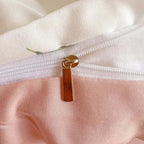 Close-up of the zipper detail on a floral cream and pink duvet cover set made from lightweight microfibre.