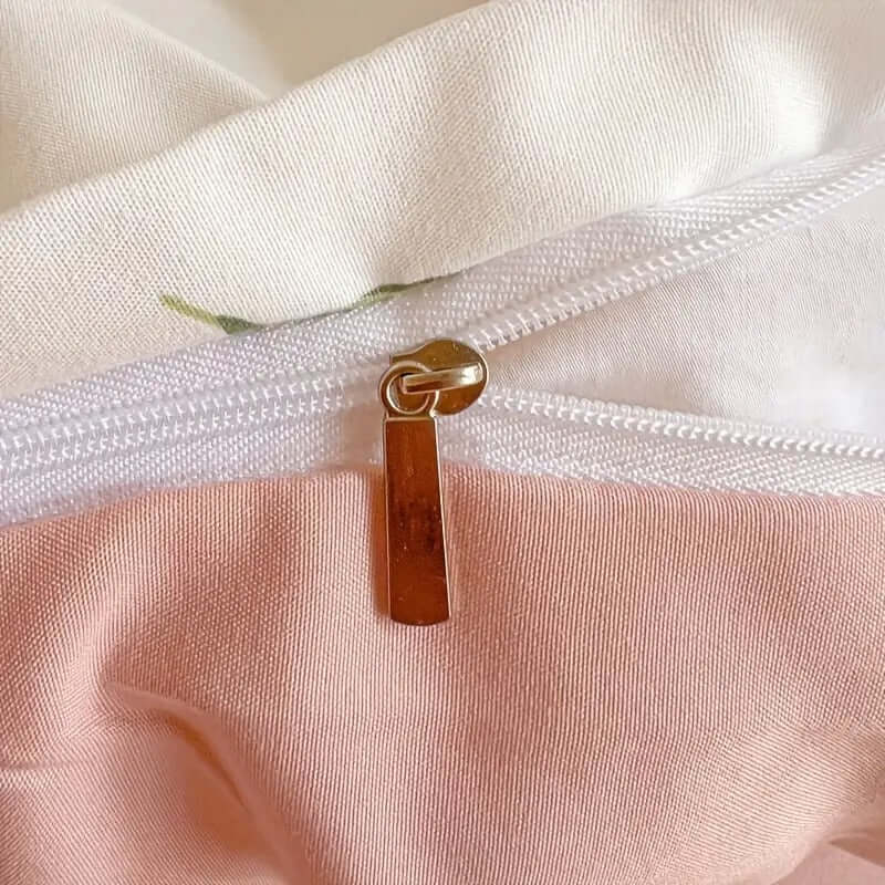 Close-up of the zipper detail on a floral cream and pink duvet cover set made from lightweight microfibre.