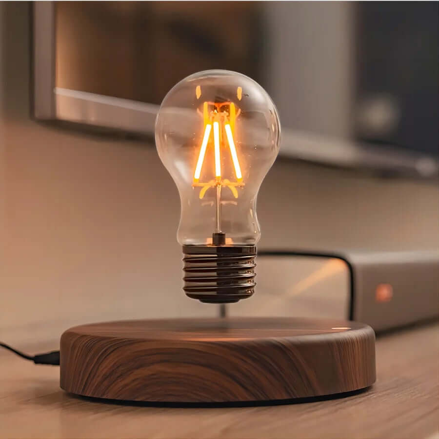 Levitating LED bulb on walnut base, showcasing magnetic floating lamp design with warm illumination.