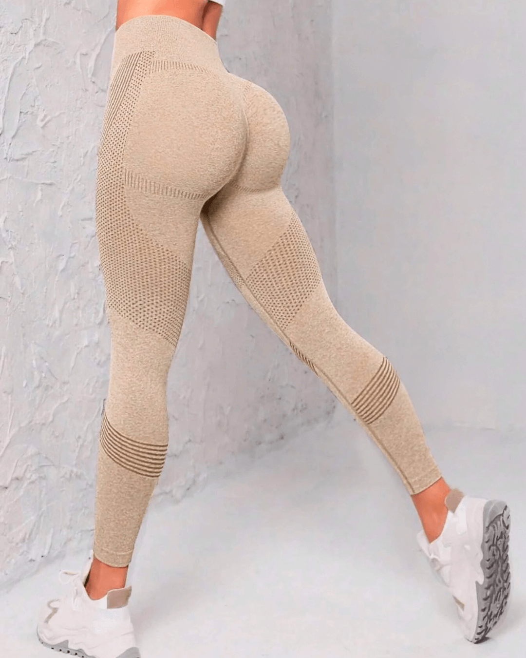 High-waist beige yoga leggings with ribbed design for butt lifting and tummy control, perfect for workouts.
