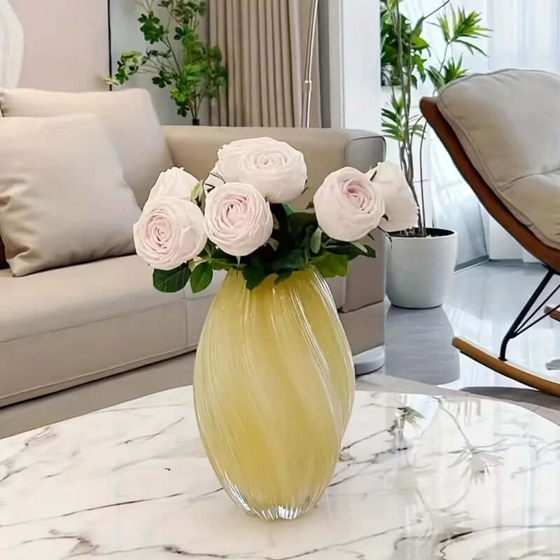 Elegant spiral glass flower vase with pink roses, perfect centerpiece for modern home decor.