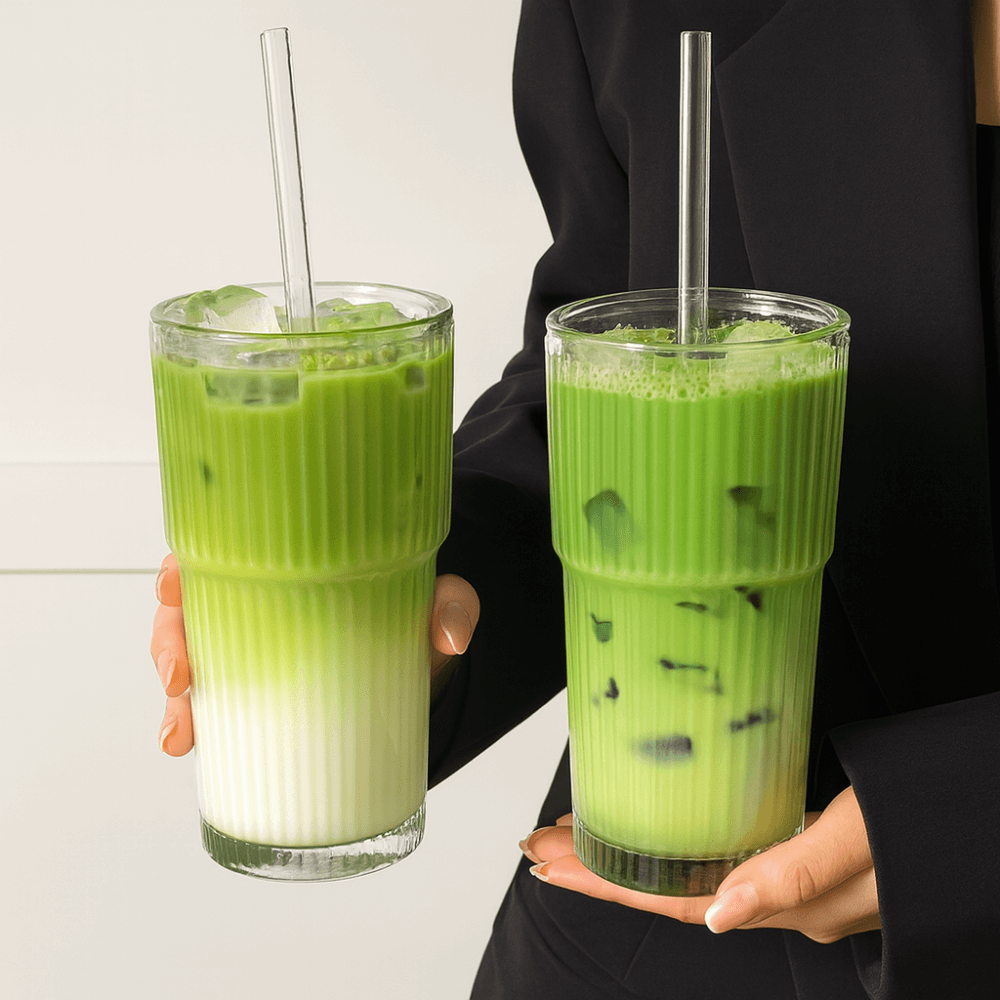 Two frosty matcha drinks in a ribbed glass tumbler with clear straw, showcasing iced matcha and layered tea.