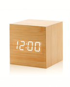 Mini LED digital alarm clock in bamboo finish displaying 12:00, featuring adjustable brightness and night mode.