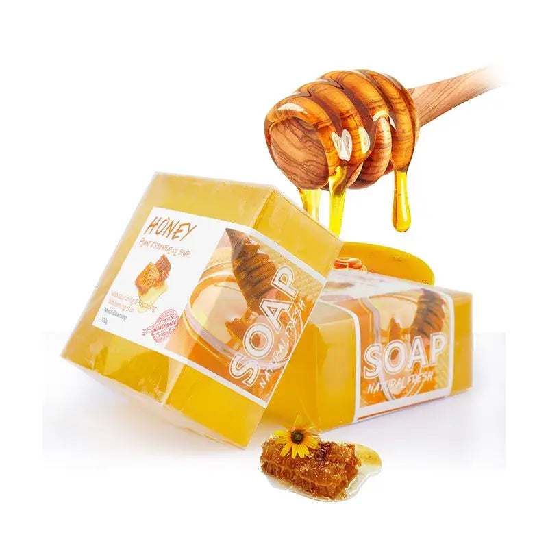 Natural honey soap bar with a honey dipper, showcasing its moisturizing properties and vibrant yellow color.
