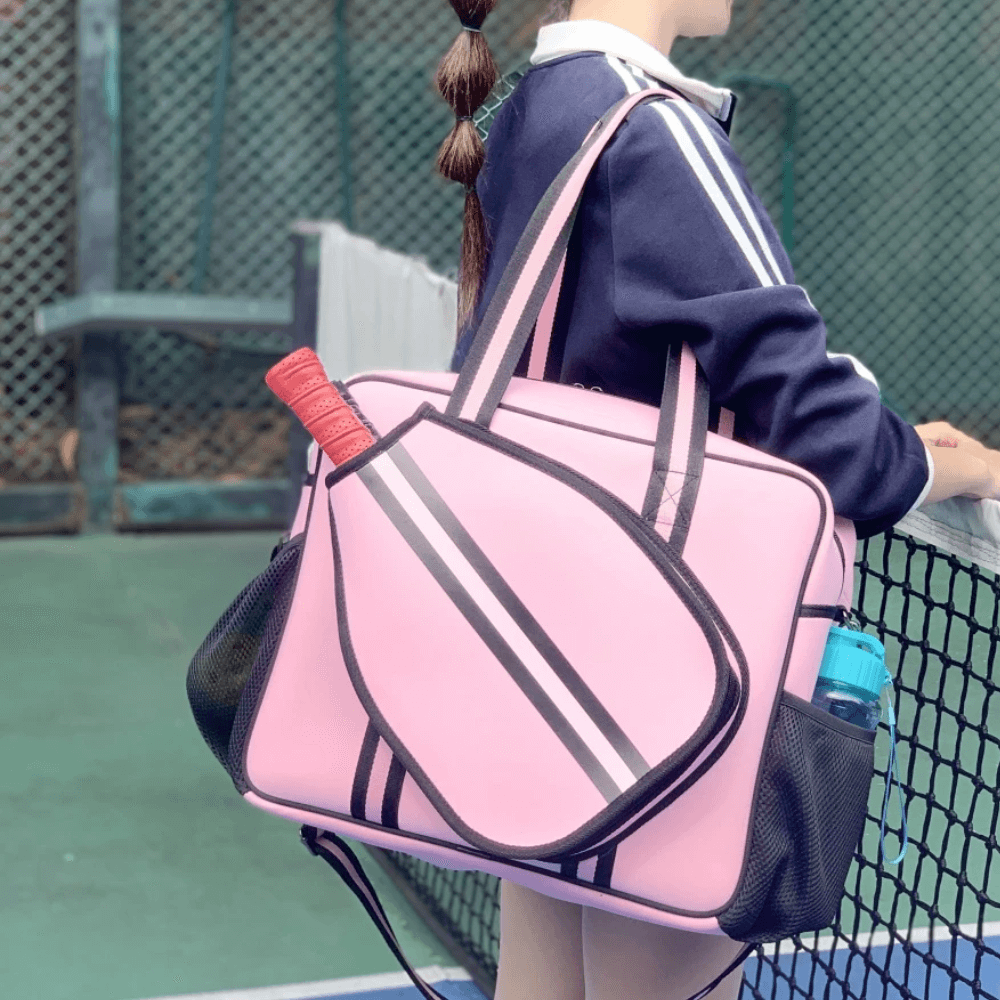 Waterproof pink padel racket bag with external sleeve and water bottle holder, perfect for court essentials.