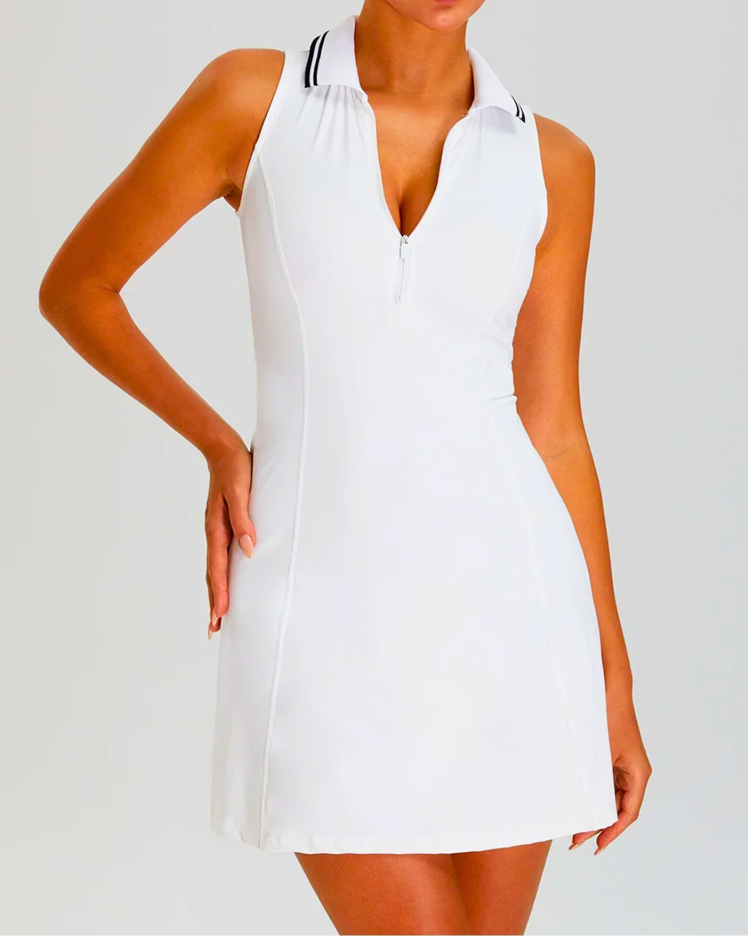 White Padel tennis dress with zip polo neck, built-in shorts, and sleeveless design for enhanced mobility.