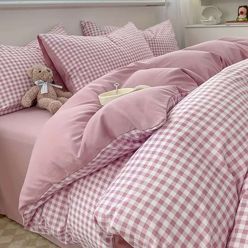Cozy Pink Gingham Bedding Set with plush pillows and teddy bear, perfect for a serene bedroom retreat.