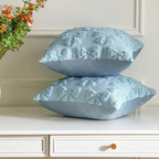 Plush quilted blue bow cushion covers set of 2, styled on a table, perfect for home decor.