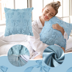 Plush blue cushion cover with quilted bow texture, perfect for adding comfort and style to any living space.