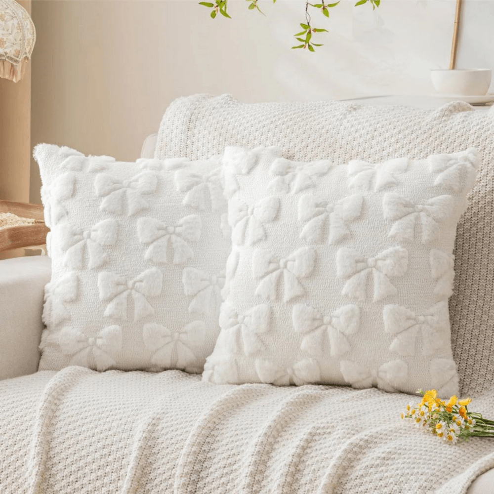 Set of 2 plush quilted cushion covers with bow pattern, perfect for sofa or bed decor.