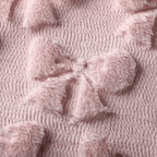 Soft quilted pink cushion cover texture featuring plush bow patterns, ideal for home decor.