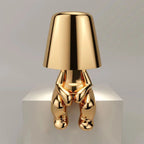 Gold LED figure lamp with a modern design and touch dimmer, perfect for creating a cozy atmosphere.