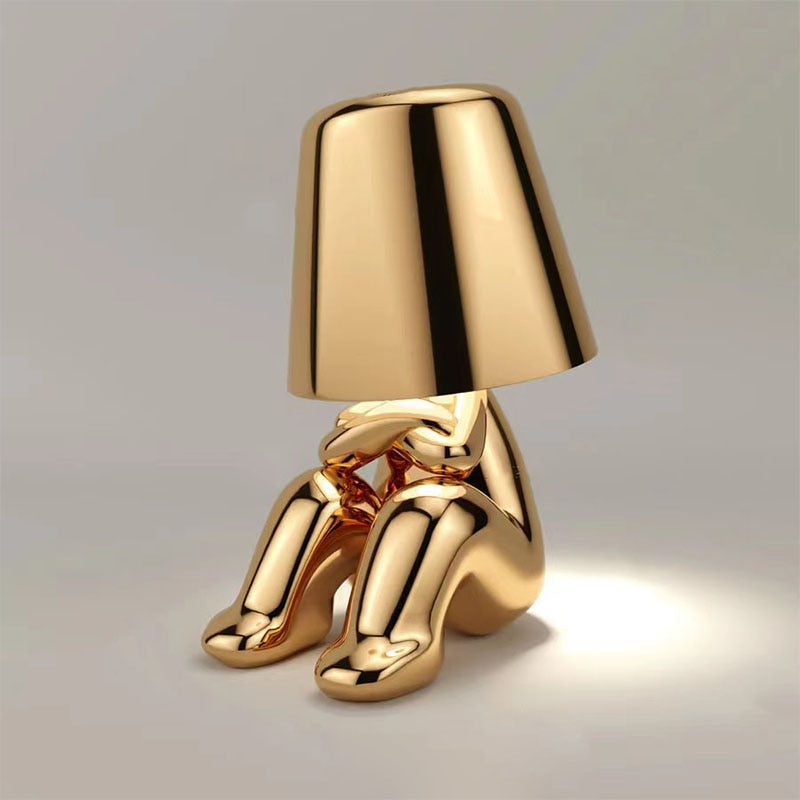 Stylish LED figure lamp in gold design, featuring a rechargeable touch dimmer for cozy ambiance.