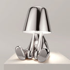 Stylish rechargeable LED figure lamp with a shiny chrome finish, featuring touch dimmer and modern design.