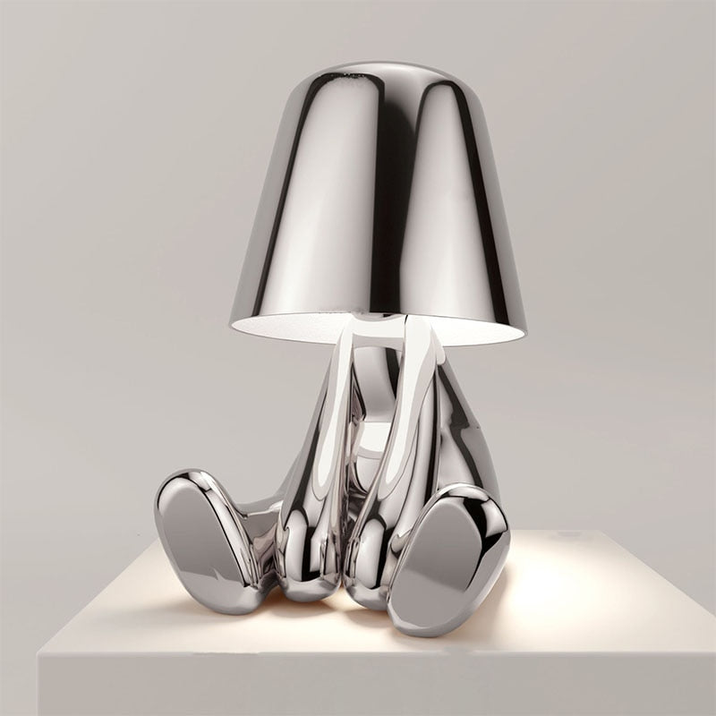 Stylish rechargeable LED figure lamp with a shiny chrome finish, featuring touch dimmer and modern design.