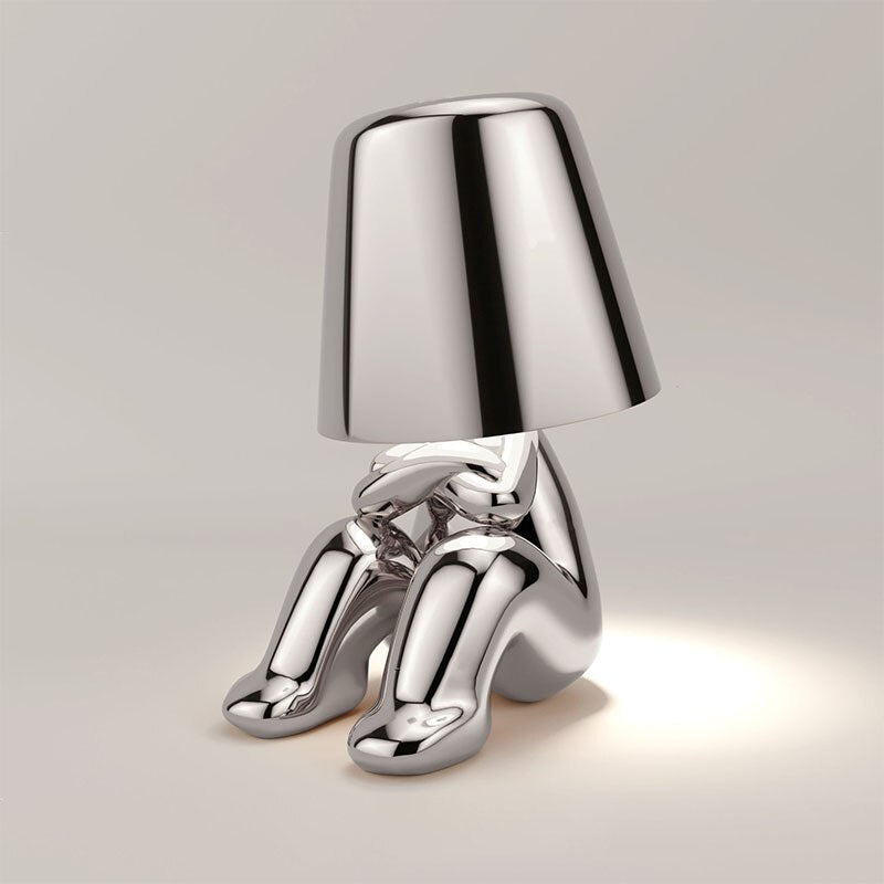 Stylish LED figure lamp with a chrome finish, featuring a cute sitting design and a touch dimmer for adjustable lighting.
