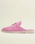 Women’s pink suede loafers with backless design and tassel accent for stylish comfort.