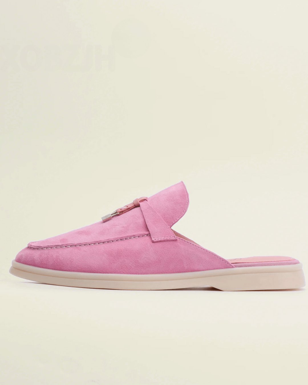 Women’s pink suede loafers with backless design and tassel accent for stylish comfort.