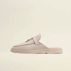 Women’s premium suede loafers with backless design and tassel accent in beige color.