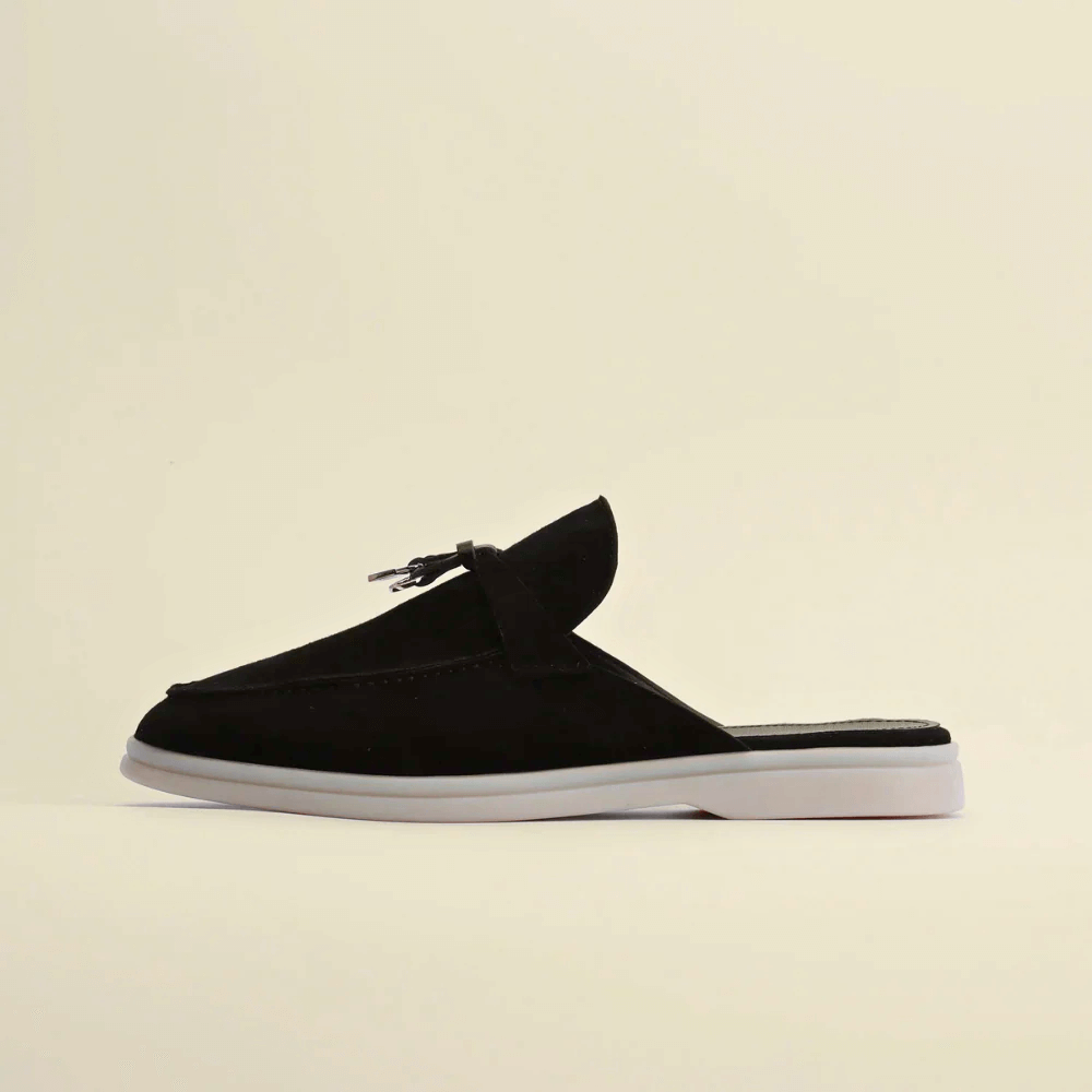 Women’s premium suede loafers in black with backless design and tassel detail for comfortable and stylish wear.