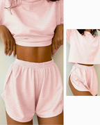 Women's striped pajama set featuring a soft short sleeve top and comfortable shorts in pink, perfect for lounging.