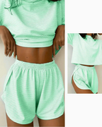 Women's green striped pajama set with soft short sleeves and comfortable shorts, perfect for warm nights.