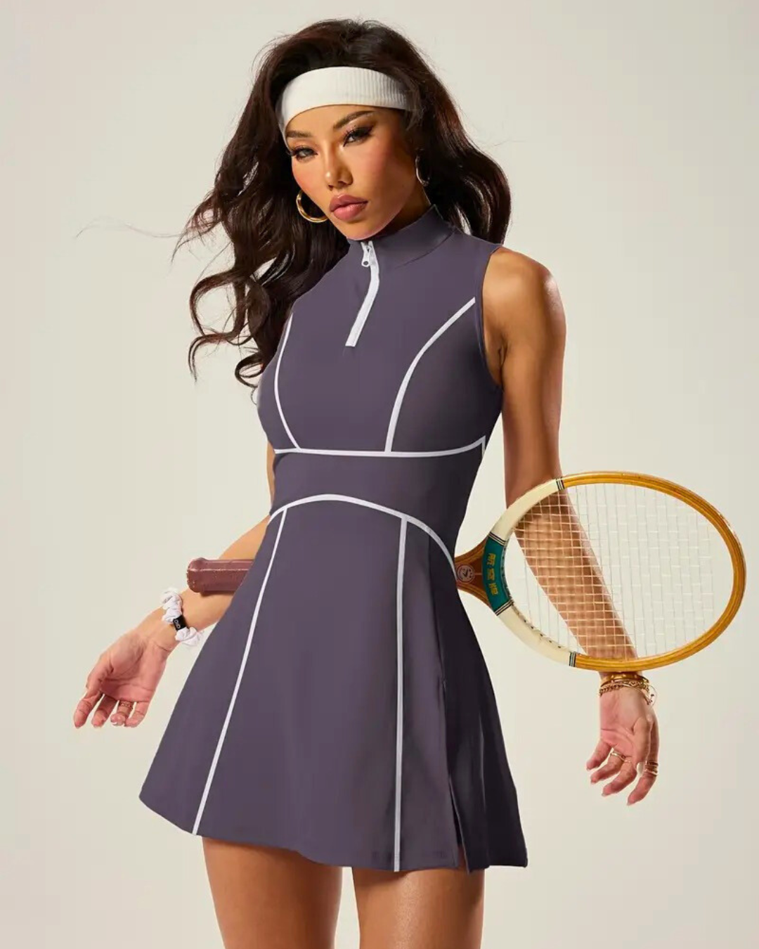 Padel tennis dress with built-in shorts, zip polo neck, stylish design, holding a racket, ready for the court.