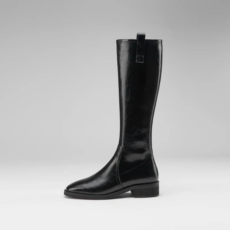 Women's knee-high black leather boots with a pointed toe and chunky heel.