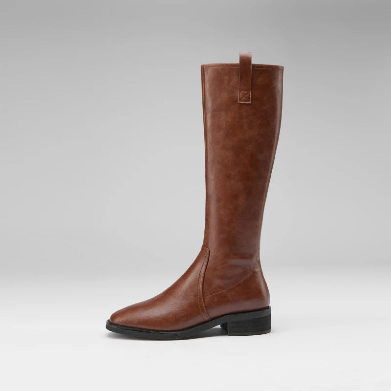 Brown knee-high leather boots with a pointed toe and chunky heel, featuring a modern and elegant design.
