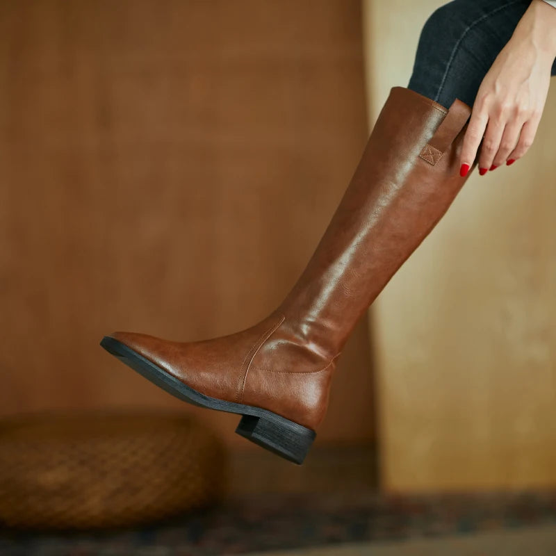 Women’s knee-high split leather boots in brown, featuring a pointed toe and chunky heel for elegant style.
