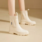 Waterproof Chelsea rain boots for women with ribbed elastic collar and chunky sole for rainy weather.