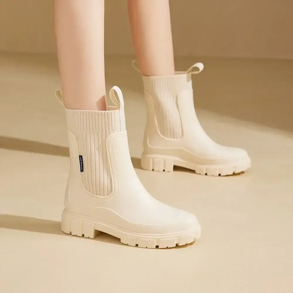 Waterproof Chelsea rain boots for women with ribbed elastic collar and chunky sole for rainy weather.