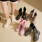 Colorful Chelsea rain boots in various shades, featuring ribbed elastic collar and chunky slip-resistant sole.