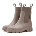 Waterproof Chelsea rain boots for women with ribbed elastic collar and slip-resistant sole.