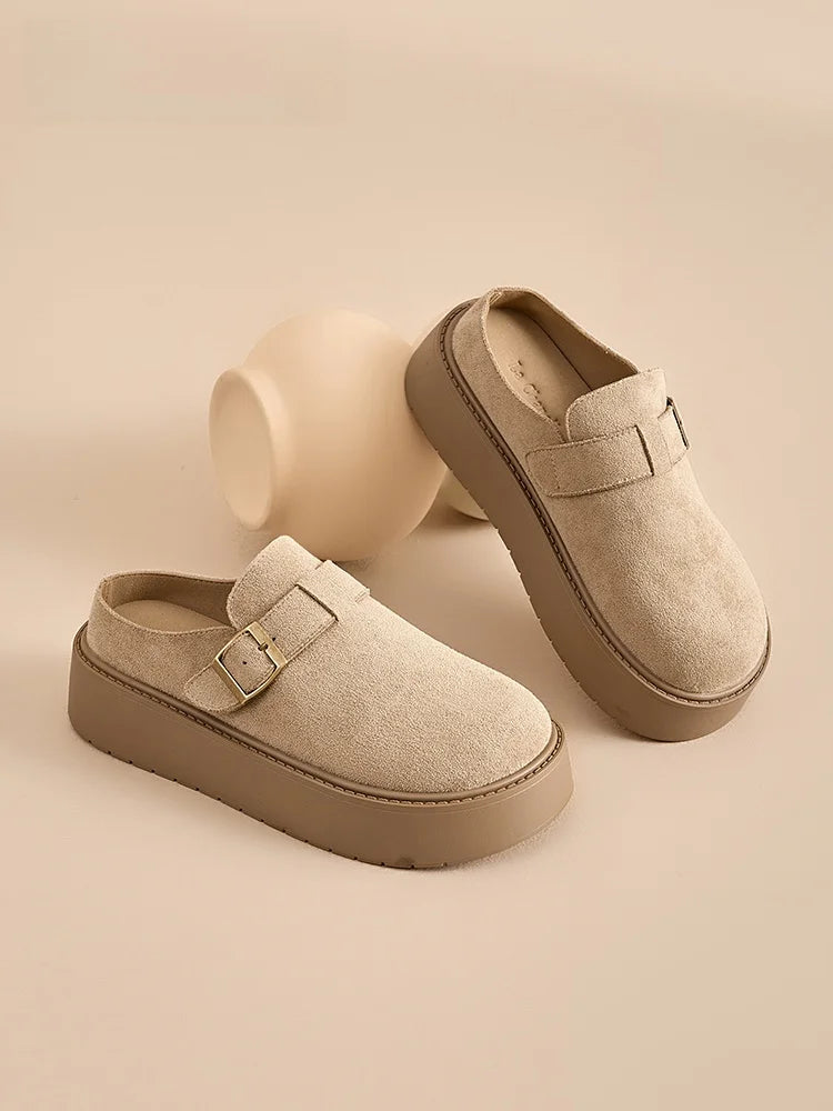 Women’s beige suede platform clog mules with buckle, perfect for casual outings and all-day comfort.