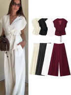 Women’s two-piece set featuring sleeveless V-neck wrap top and wide-leg trousers in various colors.
