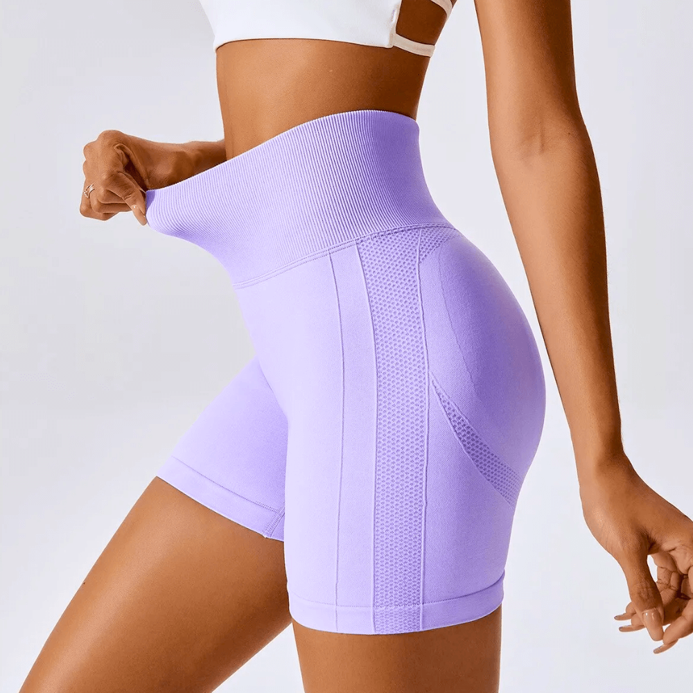 High waisted seamless purple running shorts with ribbed waistband ideal for gym and yoga workouts.