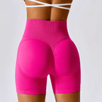 Womens high-waisted seamless workout shorts in vibrant pink, featuring a ribbed waistband and supportive fit for gym and yoga.