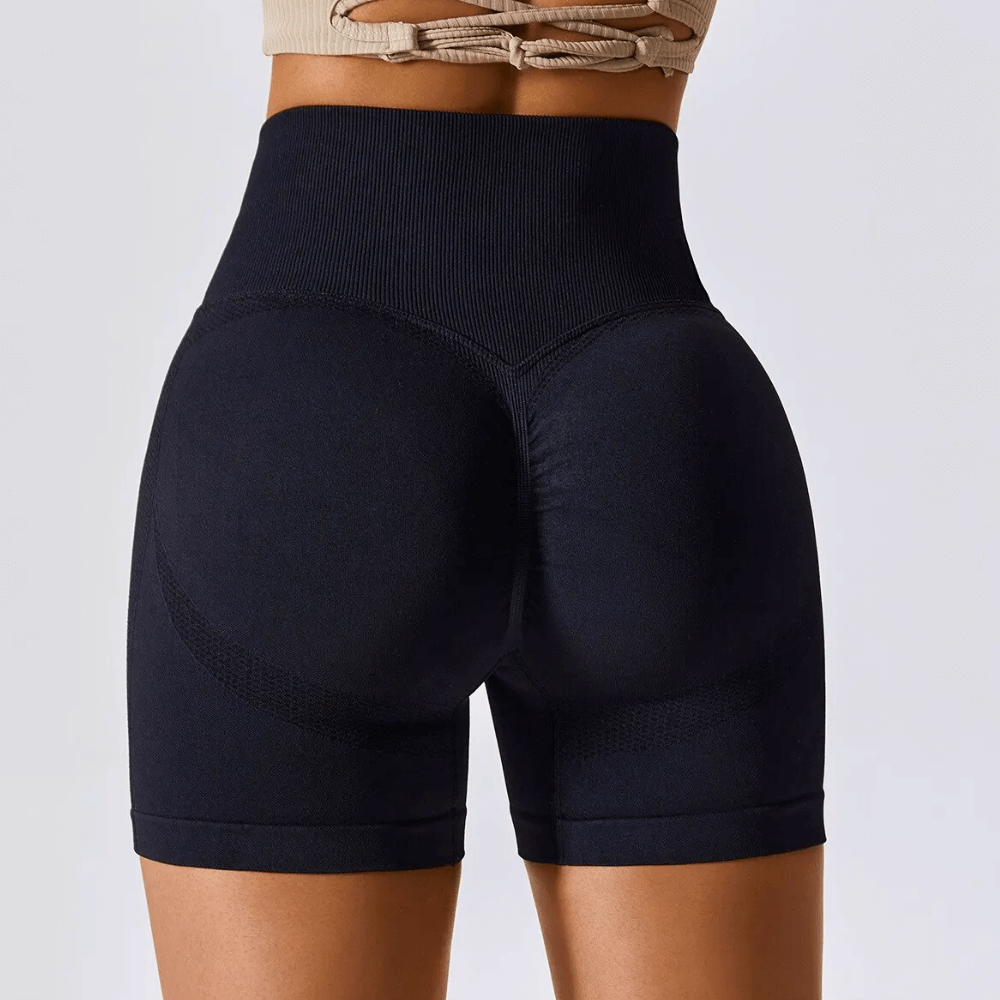 High waisted black seamless workout shorts with ribbed waistband, ideal for gym, running, and yoga exercises.