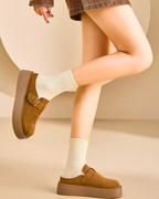 Women platform clog mules in brown suede, featuring adjustable buckle and cozy sock, styled for casual wear.