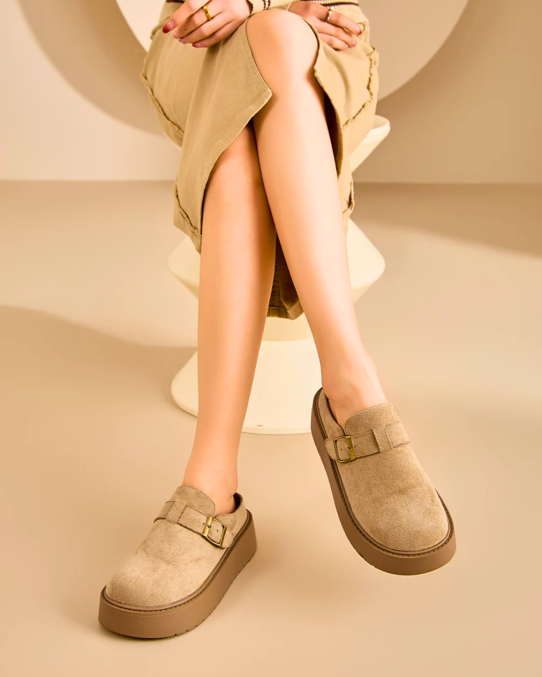 Women wearing suede platform clog mules with adjustable buckle, showcasing ergonomic comfort and stylish design.