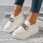 Stylish white orthopedic women's walking shoes with chain detail, designed for comfort and support.