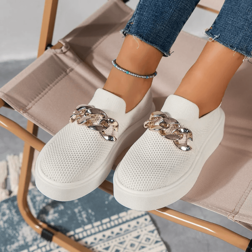 Stylish women's white mesh slip-on shoes with decorative chain detail, perfect for casual wear.