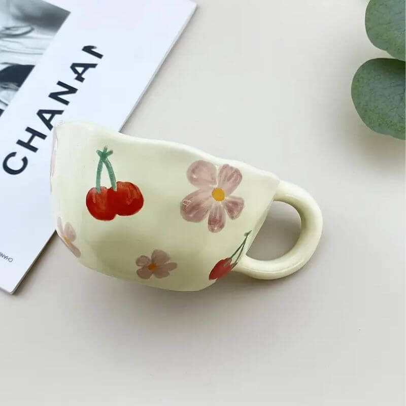 Flower pattern ceramic mug with cherry and floral designs, ideal for coffee, tea, or milk.